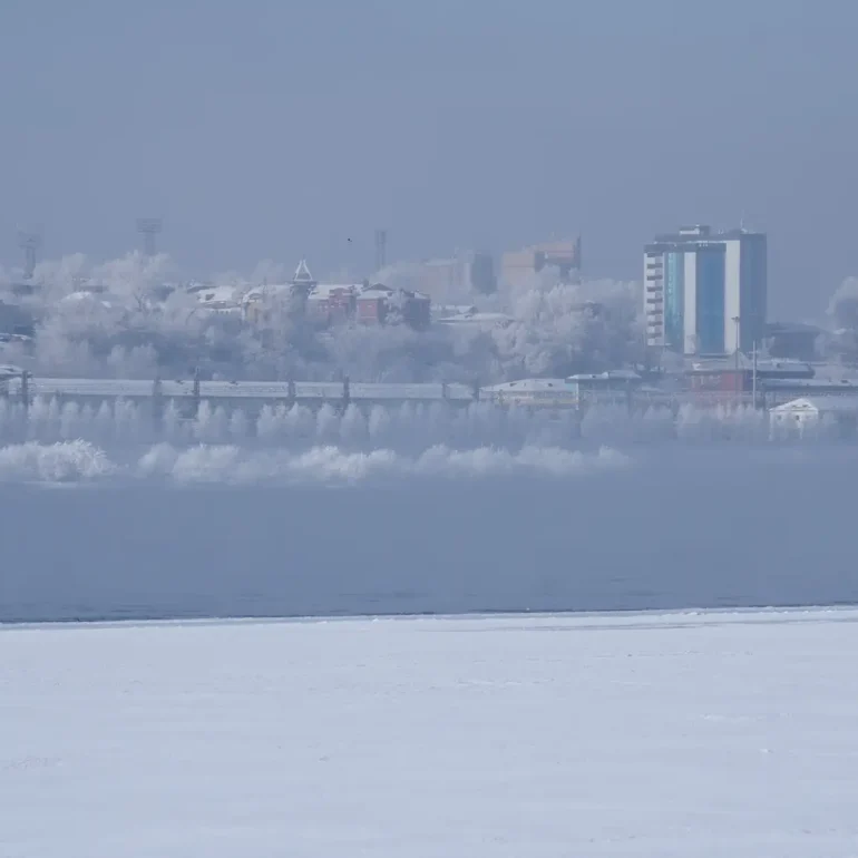 Snow-covered winter landscape near Novosibirsk in Siberia, Russia, surrounded by ice and the silence of a freezing winter day.