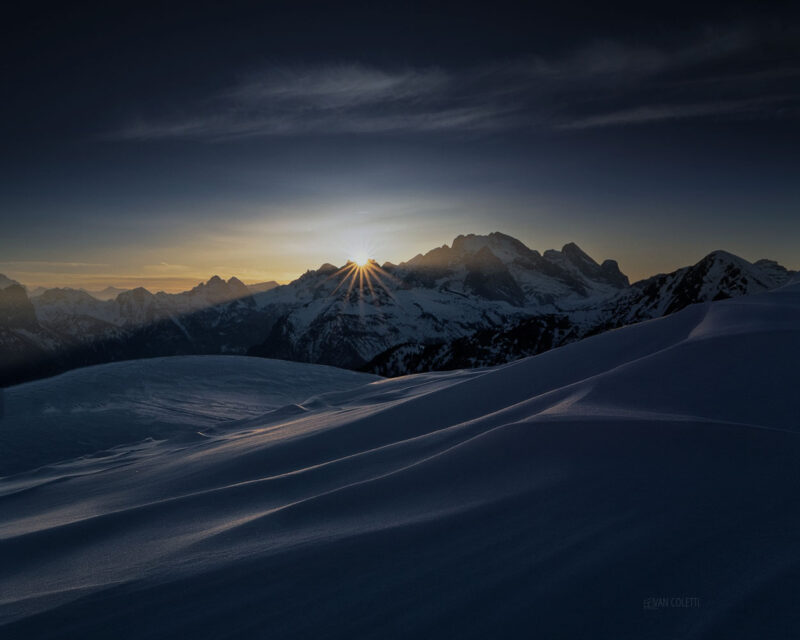 The snow-covered Marmolada glowing beneath the last golden light of a winter day in the UNESCO-listed Italian Dolomites.