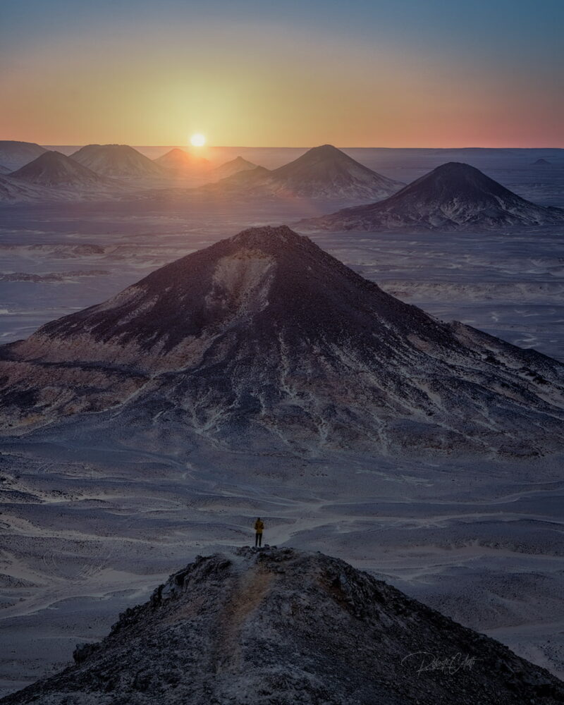 Black volcanic hills glowing at sunset in Egypt
