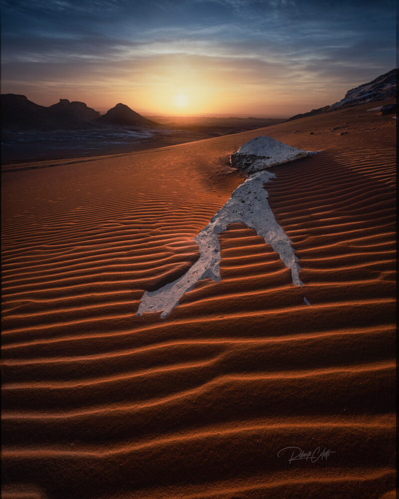 White chalk rock formation in the foreground illuminated by sunrise in Egypt