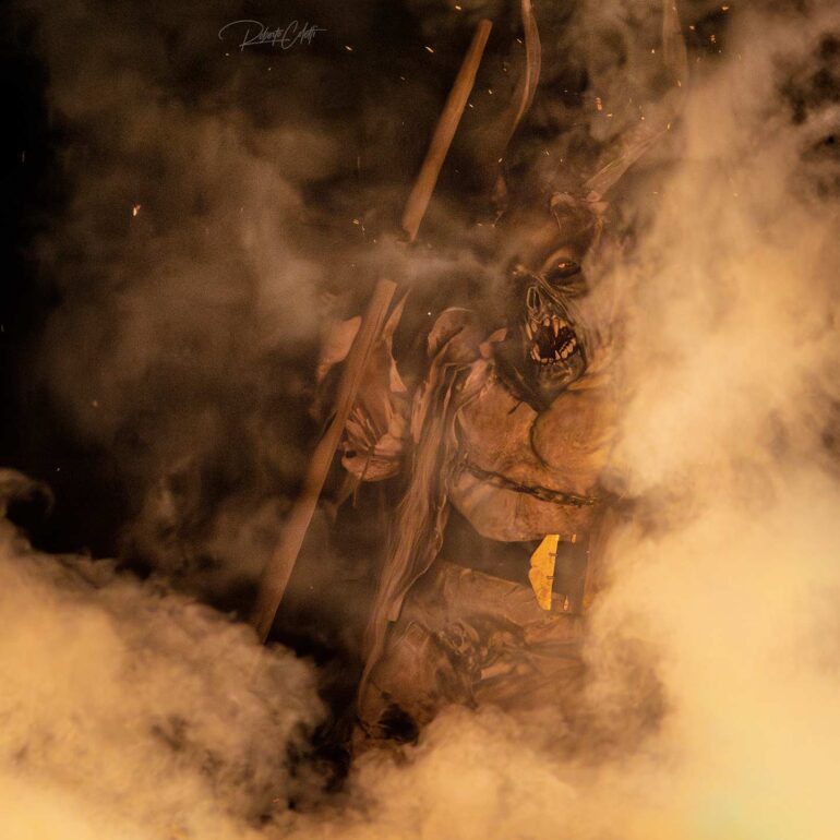 Traditional Krampus festival in December with fire, masks and ancient alpine traditions in Italy.