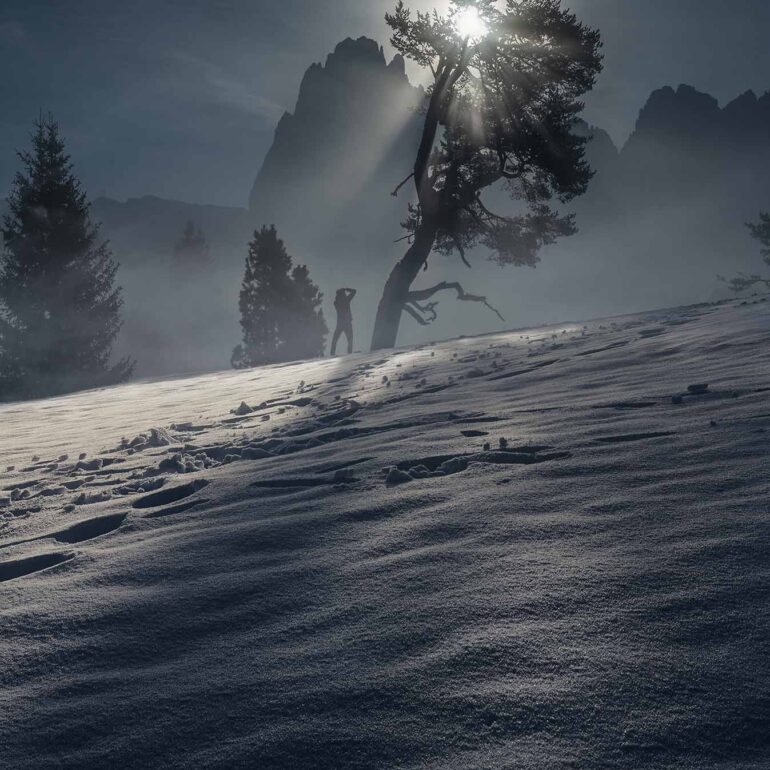 Backlit fresh snow across Alpe di Siusi (Seiser Alm) in the Italian Dolomites after a winter snowfall, glowing in warm mountain light.