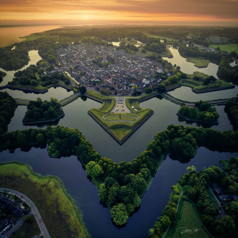 Aerial view of the historic star-shaped fortress of Naarden in the Netherlands, revealing its remarkable geometric design.